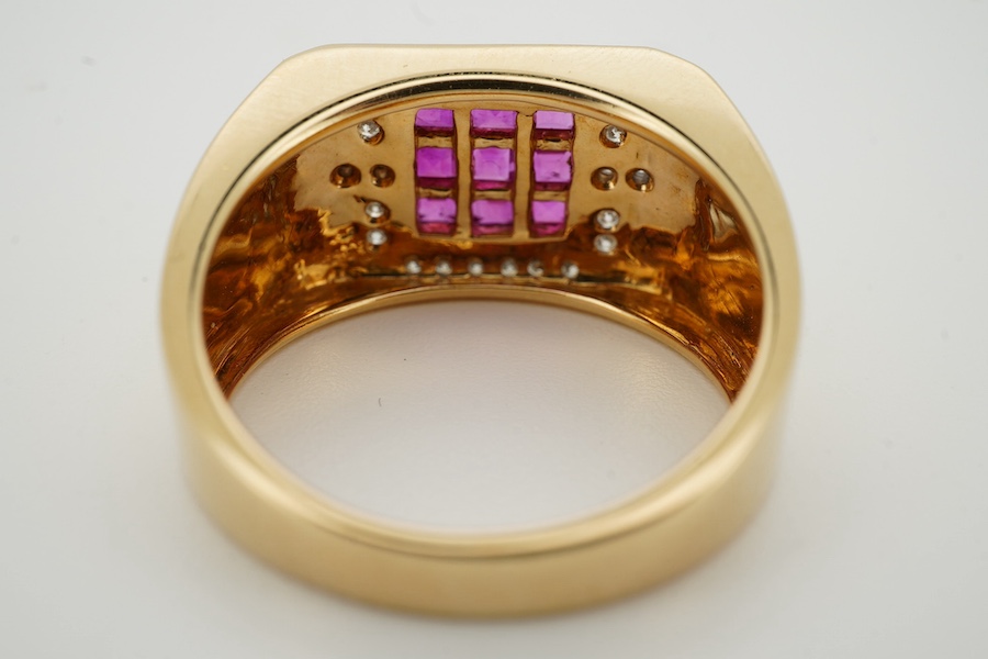A modern 18k, ruby and diamond set square cluster dress ring, size R/S, gross weight 8.1 grams. Condition - good